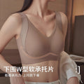 A woman wearing a ribbed, wireless bra in a warm taupe-beige color, shown from the chest up in an indoor setting. Chinese text is overlaid at the bottom describing the product as a soft承托片 with W-shaped support.